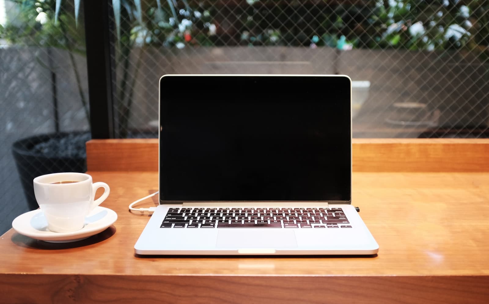 Digital nomad working on a laptop in a cafe while travelling