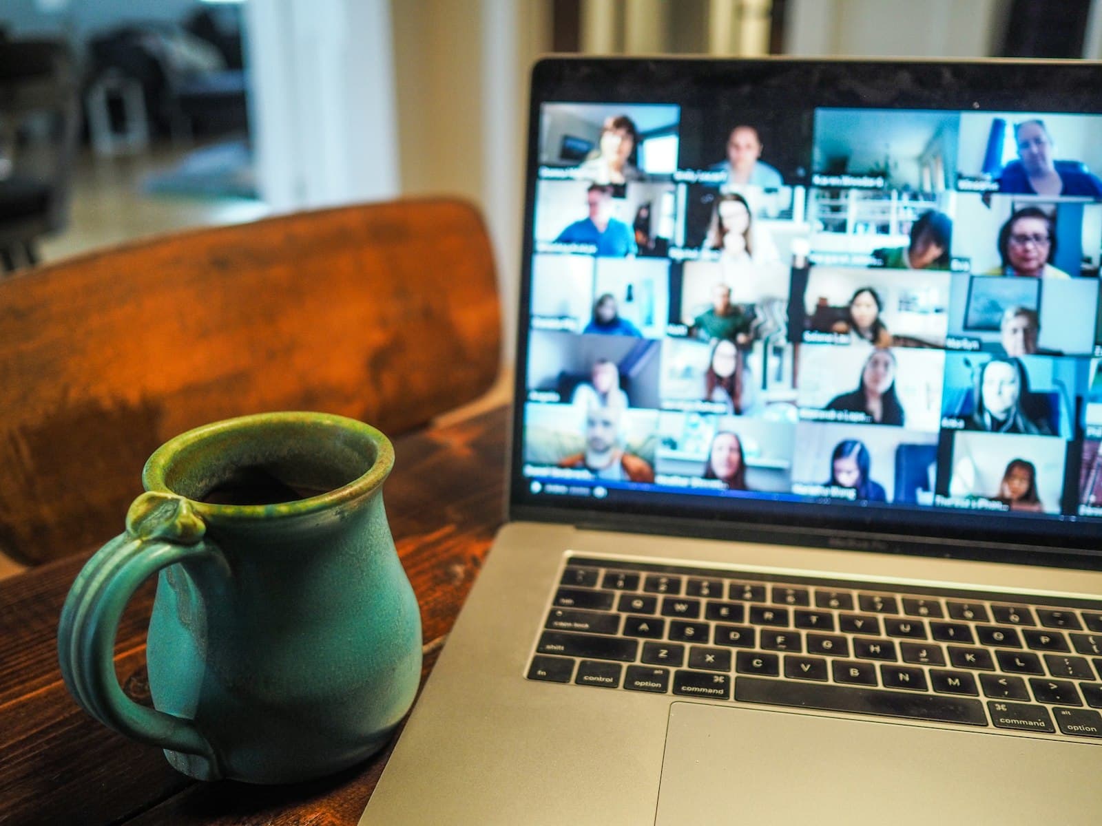 Distributed team on a video call, laptop on a desk